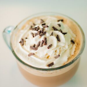 ice cream with white cream on clear glass cup